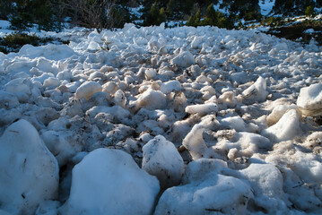 Remains of a snow avalanche. Mass of snow, displacement of a layer of snow in a sloping area that...