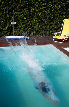 A woman diving into the swimming pool