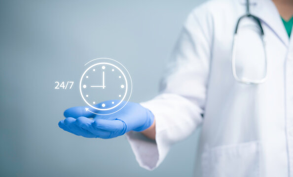 Medical worker holding 24-7 service icon for assistance patient when accident or emergency. Medical call center service with out interruption day and night. Pharmacy service 24 hours a day. - Powered by Adobe