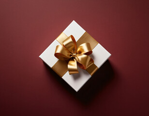 Obraz na płótnie Canvas A white gift box adorned with a sumptuous gold ribbon, presenting a luxurious touch against a rich burgundy background, evokes exclusivity and celebration. Generative AI.