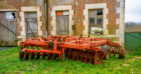 Close up of a large old harrow machine
