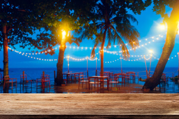 wooden table, beach bar, restaurant, Nighttime Tropical Paradise with party light bulb Palm-lined...