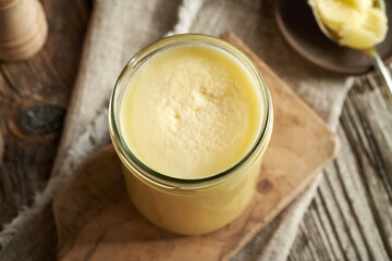 Ghee or clarified butter in a glass jar on a table