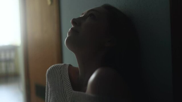 Portrait of sad young woman looking up suffering from depression anxiety loneliness or mental health problem at home Thoughtful female upset feeling stress and pressure indoors