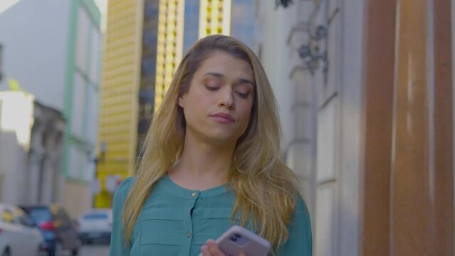 transgender business woman using smartphone texting walking on the street checking email messages online successful transgender
