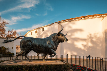 Bull statue in front of the bullring (Plaza de Toros) of Ronda, Andalusia, Spain. Ronda bullring is...