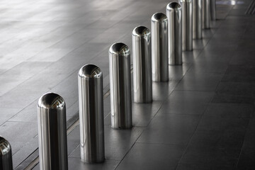 steel bollards on footpath in front of the hotel building.