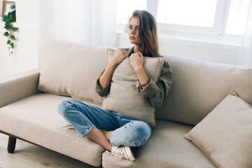 Obraz premium Lonely Woman on Couch: Stress, Depression, and Anxiety in Home