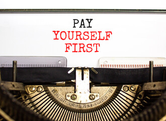 Pay yourself first symbol. Concept words Pay yourself first typed on beautiful old retro typewriter. Beautiful white paper background. Business and pay yourself first concept. Copy space.