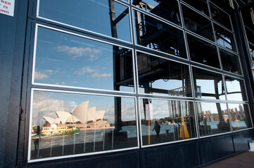 Reflection of Sydney Opera House in windows of a building