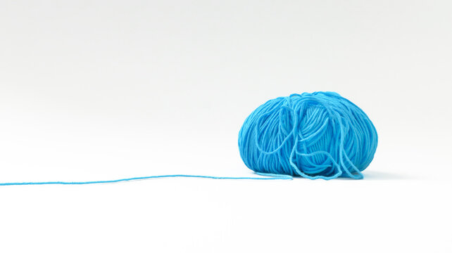 A ball of blue yarn is on a white background.
