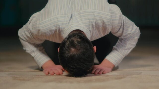 Frontal Shot of a Muslim Man Bowing on the Mosque Carpet in Islamic Prayer 