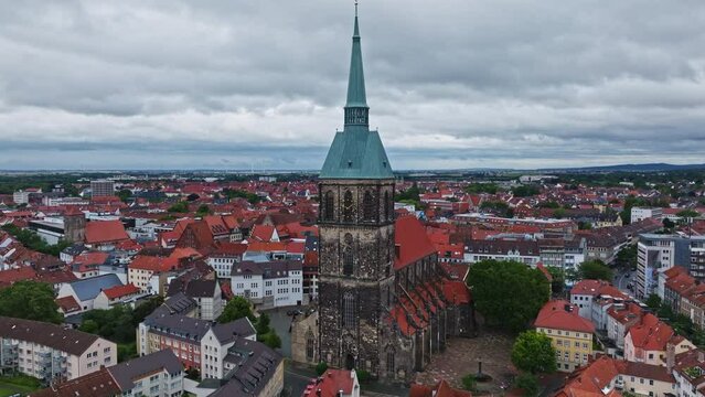 Aerial Drone view of The church of St. Andreas or Andreaskirche , it is the principal Lutheran church of Hildesheim, Germany. Its is the tallest church tower in Lower Saxony