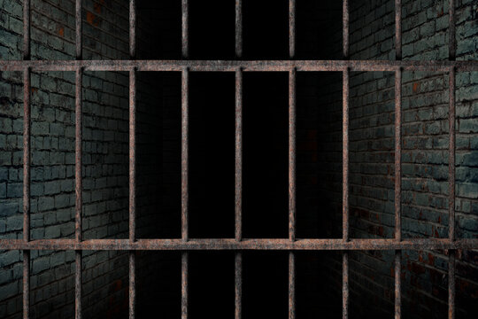 Dark and dim space in an empty prison cell with old brick walls. and old rusted iron bars, The concept of fear and lack of freedom