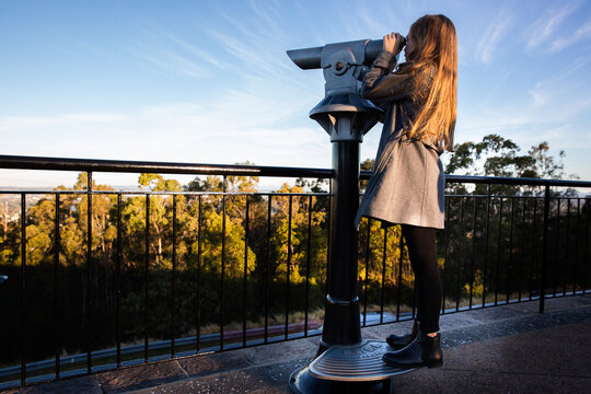 girl using a lookout telescope