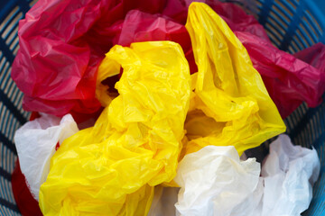 Used plastic bags in blue plastic basket