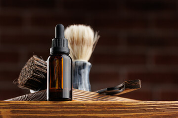 Bottle essential oil for beard men on background dark brick. Concept banner spa barbershop...