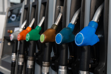 Petrol pump filling nozzles at station gas