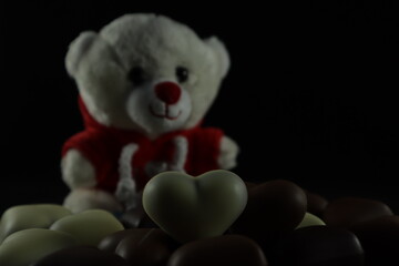 Teddy bear with heart-shaped chocolate