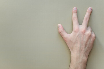 a young man shows gestures of the deaf and dumb. the language of people with disabilities. sign language