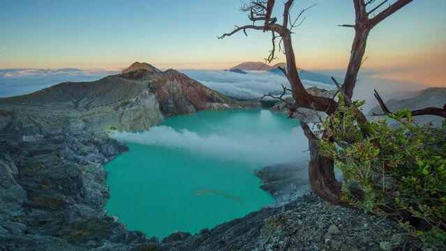 Timelapse mount Kawah Ijen active volcano with smoke coming out of main crater during sunrise, Java, Indonesia 