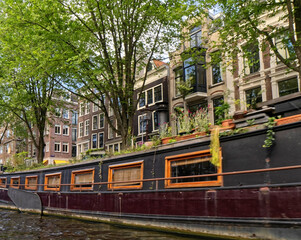 Fototapeta na wymiar Amsterdam, the Netherlands - view of the old town from the water canal