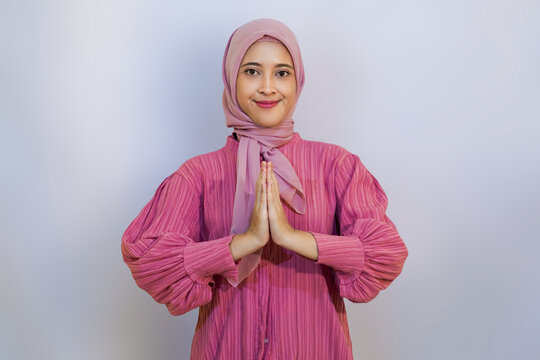 Pretty young Muslim woman giving salam advertising concept.