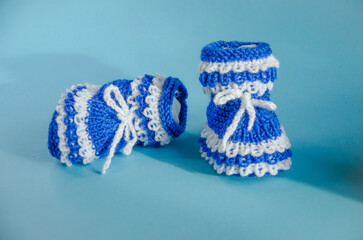 blue knitted booties on a blue background