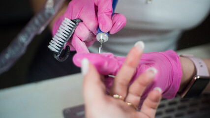 a girl gets a manicure in a beauty salon