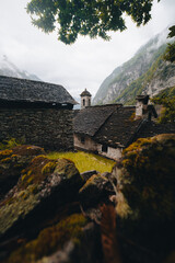 Sonogno village in Swiss alps with waterfall nearby. - 726634371