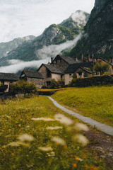 Sonogno village in Swiss alps with waterfall nearby. - 726634383