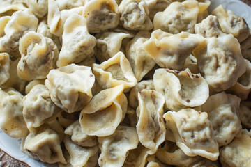 Small dumplings in the shape of an animal ear with mushroom stuffing. Traditional Polish food served on Christmas Eve dinner with red borscht