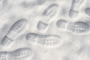 Tracks of shoes in the shallow snow. Winter footwear trace. Shoe marks on fresh snow