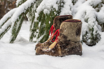 Winter scene with snow boots made of reindeer skin