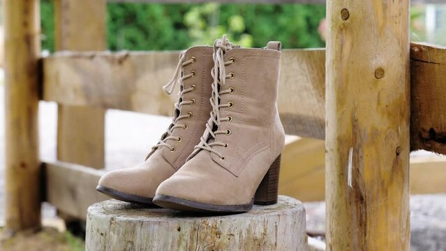 boots by a wooden fence