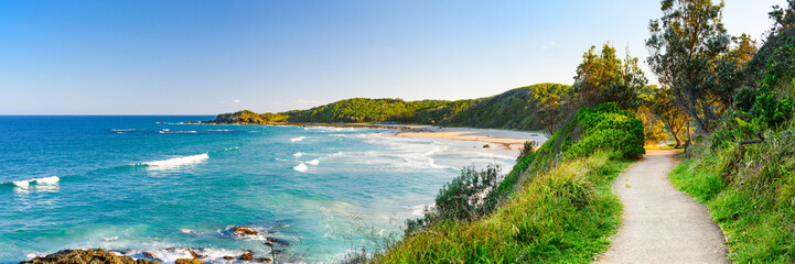 Australian coast with blue water and hills on the ocean shore, view from coastal walk of the sea...