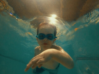 Little Boy Swimming from underwater
