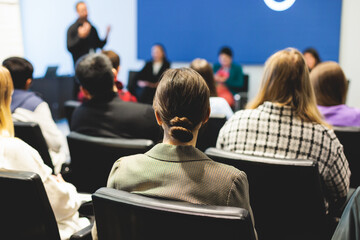 Female participants audience at the symposyum meeting, attendees in conference room hall listens to...