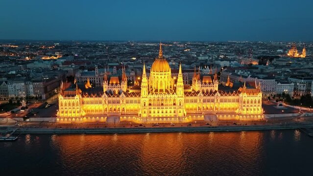 Residence of Hungarian Parliament, Budapest Aerial view national building symbol night city lights against backdrop sunset evening on sunny day in summer view from other bank of Danube River. Travel