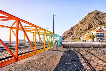 Papier Peint photo les îles Canaries Tenerife, Spain - December 25, 2023: Colorful footbridge linking San Andres to Playa de las Teresitas on the island of Tenerife in Spain's Canary Islands 