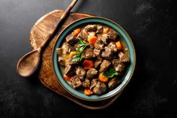 Beef meat goulash with carrot and onion, beef and carrot stew, top view