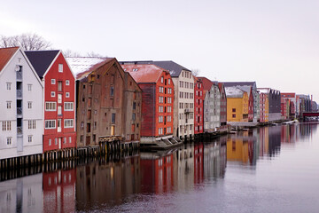 Fototapeta na wymiar Colorful old houses on the water in Trondheim Norway in winter
