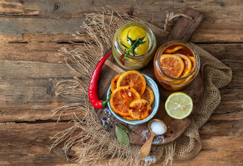 Fermented lemons in jars of salt, chili pepper and rosemary. Traditional food additive in the Middle East, India and North Africa