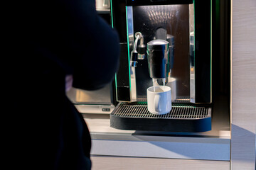 close-up of the process of making fragrant coffee with an automatic coffee machine in a hotel