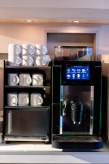 beautiful metal automatic coffee machine with touch screen in hotel restaurant making hot drinks