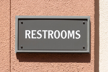 Restrooms sign with braille characters for the visually impaired and blind people. - obrazy, fototapety, plakaty