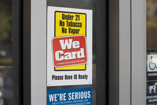Irvine, CA, USA - May 7, 2022: We Card sign is seen outside a store in Irvine, California. We Card is a "youth smoking prevention" program created by the Tobacco Institute.
