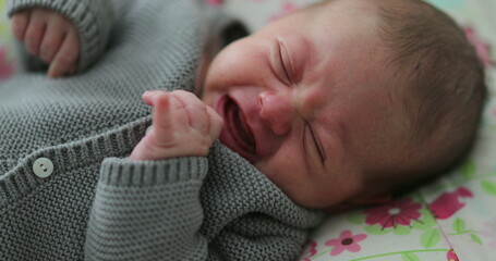 Crying newborn baby infant cries first month old