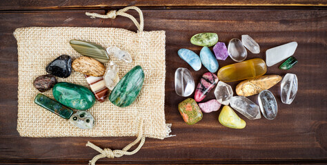 Colorful mineral crystal stones on wooden background. Gemstone jewelry banner with copy space.