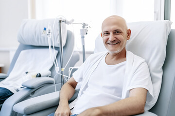 Obraz premium Cancer patient Bald man smiling in hospital bed, drip stand in background, conveying hope and positivity. Concept desire for life, treatment of fatal disease